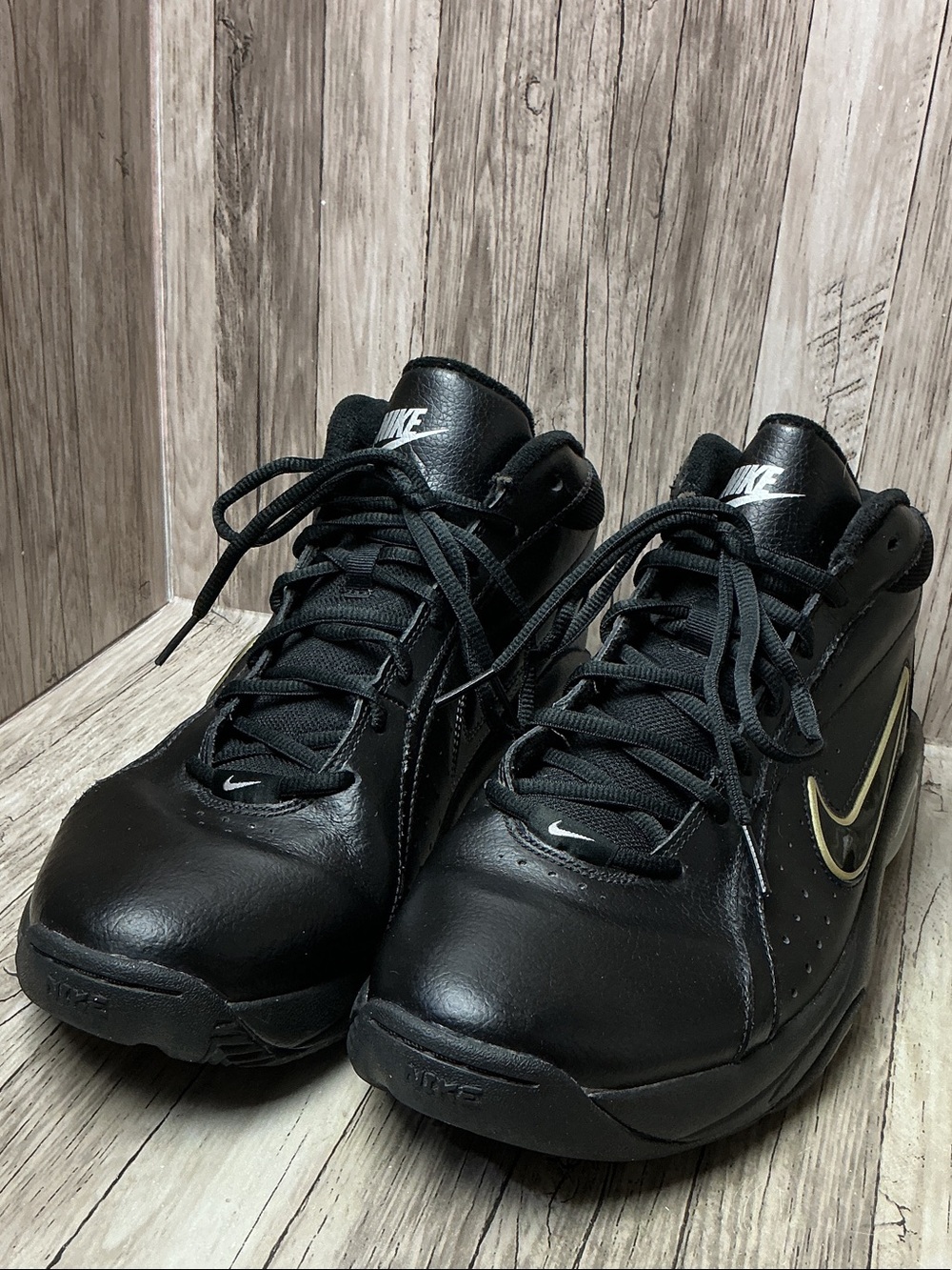 Nike Black Leather Sneakers with Gold Swoosh Accent